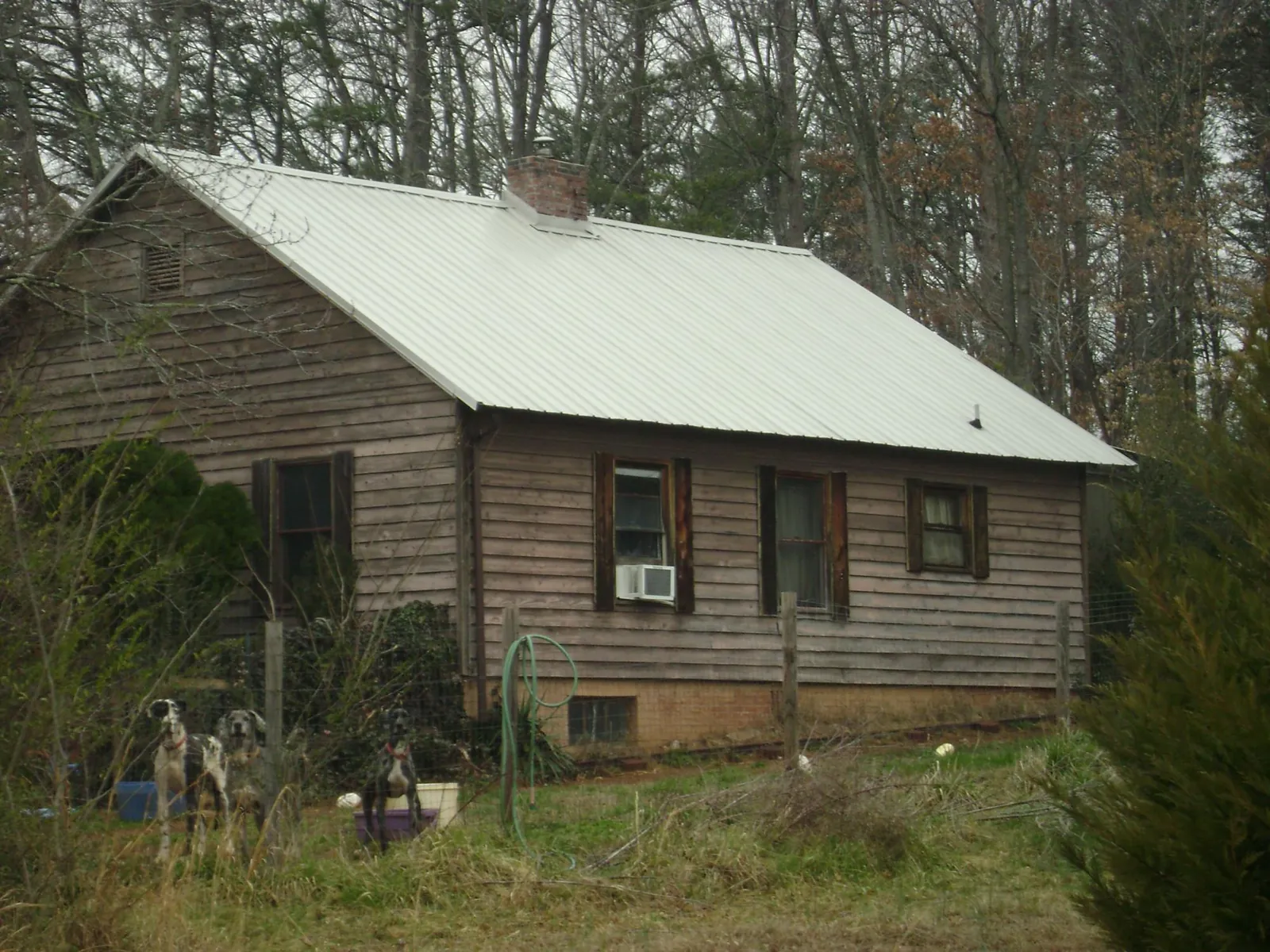 White metal roof on an old wood sided farmhouse, from a Metal Roof Installation job in Kuna